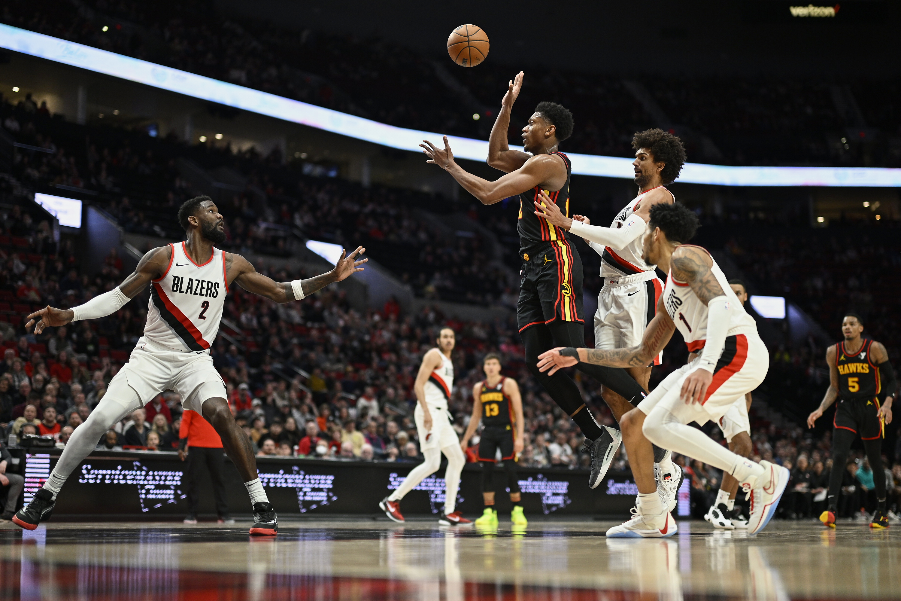 Mar 13, 2024; Portland, Oregon, USA; Atlanta Hawks forward De'Andre Hunter (12) passes the ball during the second half against Portland Trail Blazers guard Matisse Thybulle (4) and center Deandre Ayton (2) at Moda Center. Mandatory Credit: Troy Wayrynen-USA TODAY Sports